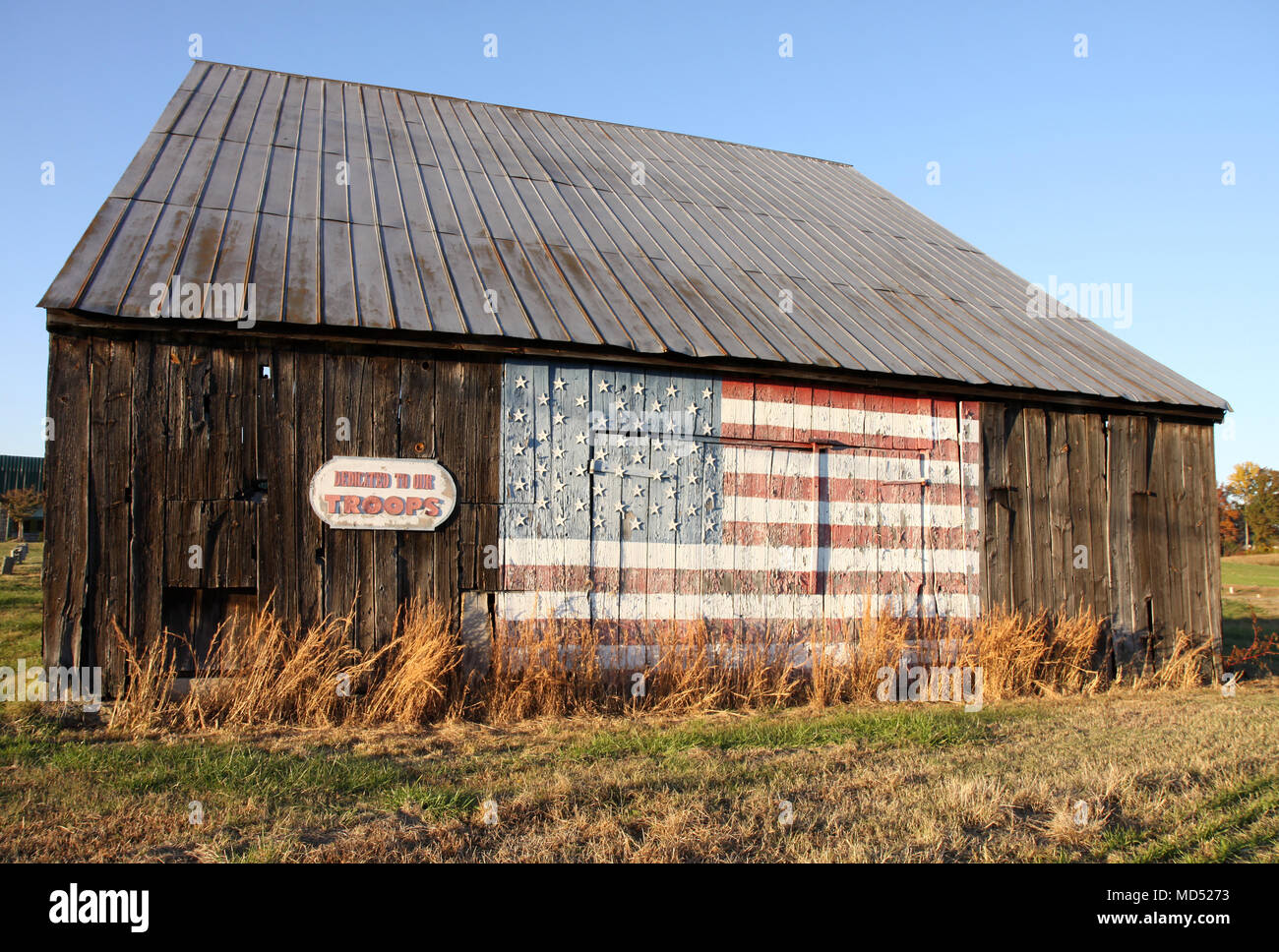 Old Wooden Tobacco Barn With American Flag Painted On Side Facing