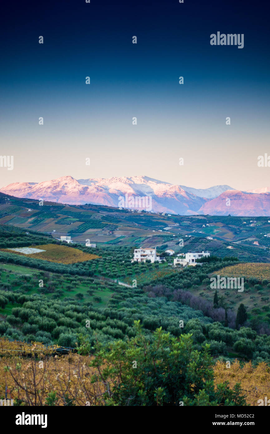 Scenic view of a landscape with snow clad mountains at backdrop, Greece Stock Photo