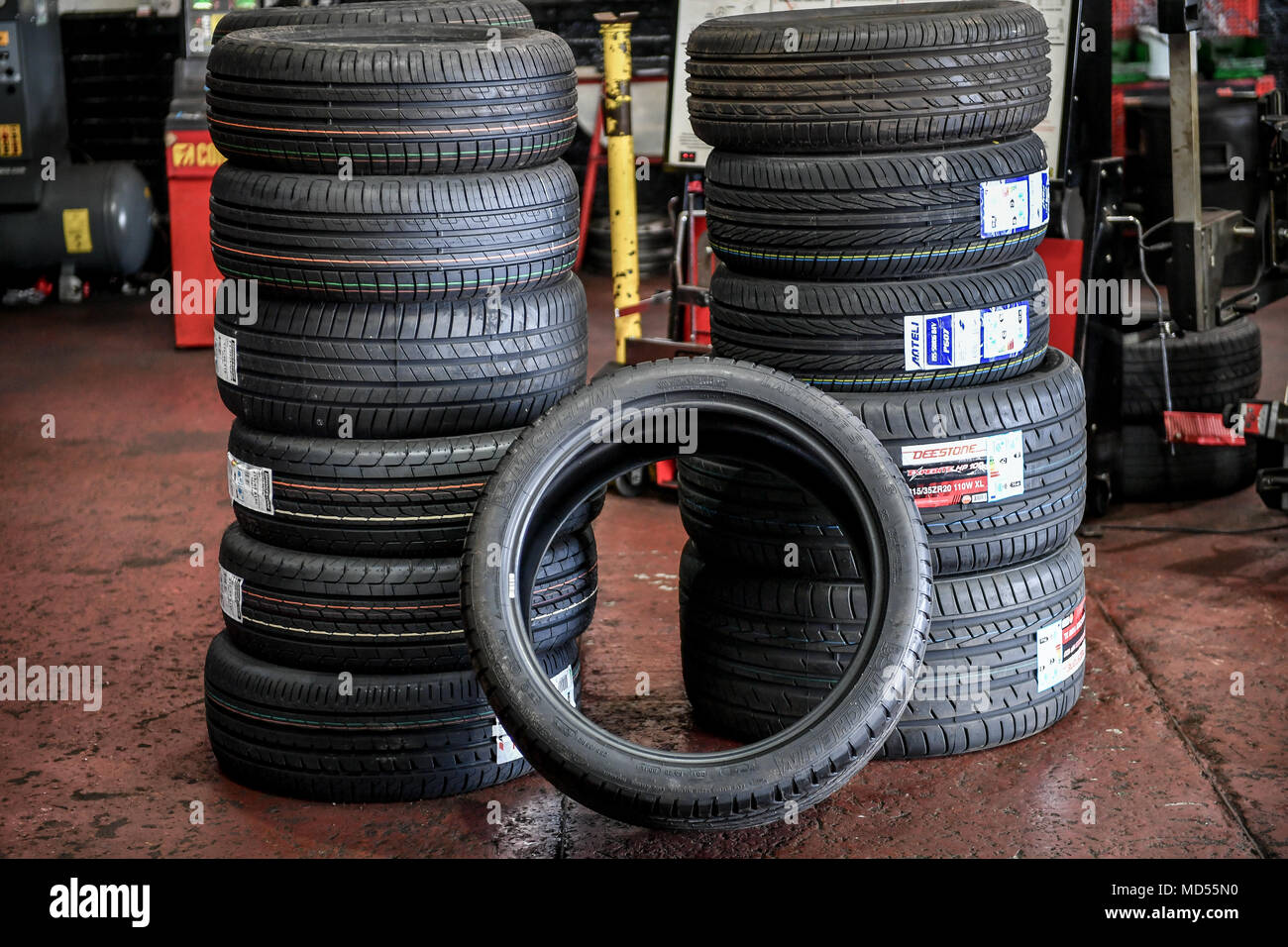 A stack of car tyres in a garage Stock Photo Alamy