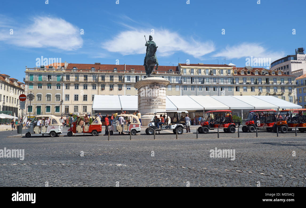 LISBON, PORTUGAL - JUNE 25, 2016: Tuk tuks of the local guide tours parking on the square of the Fig Tree (Praca da Figueira) in front of the bronze e Stock Photo