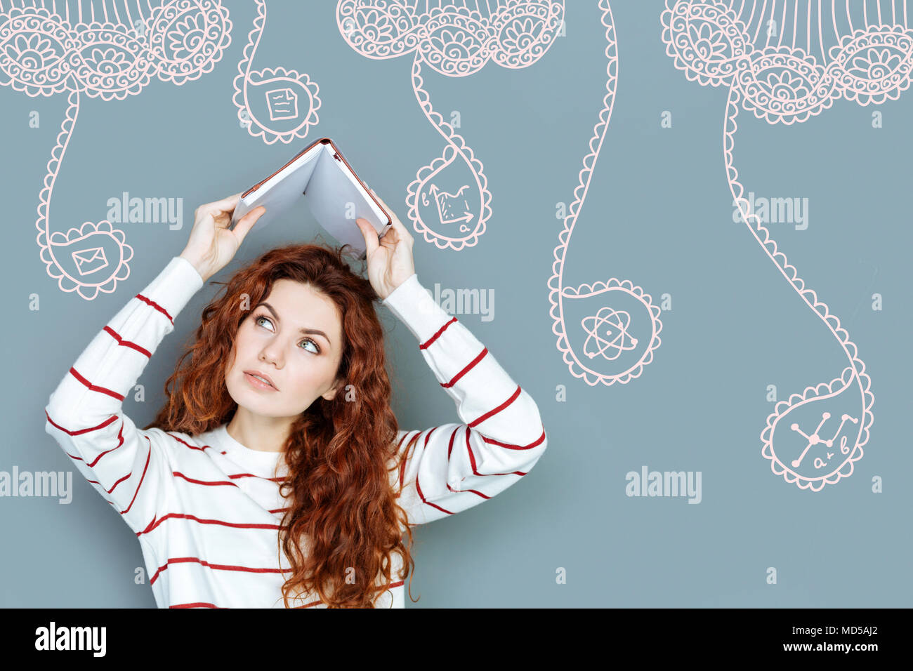 Busy student putting a book about her head while thinking Stock Photo ...
