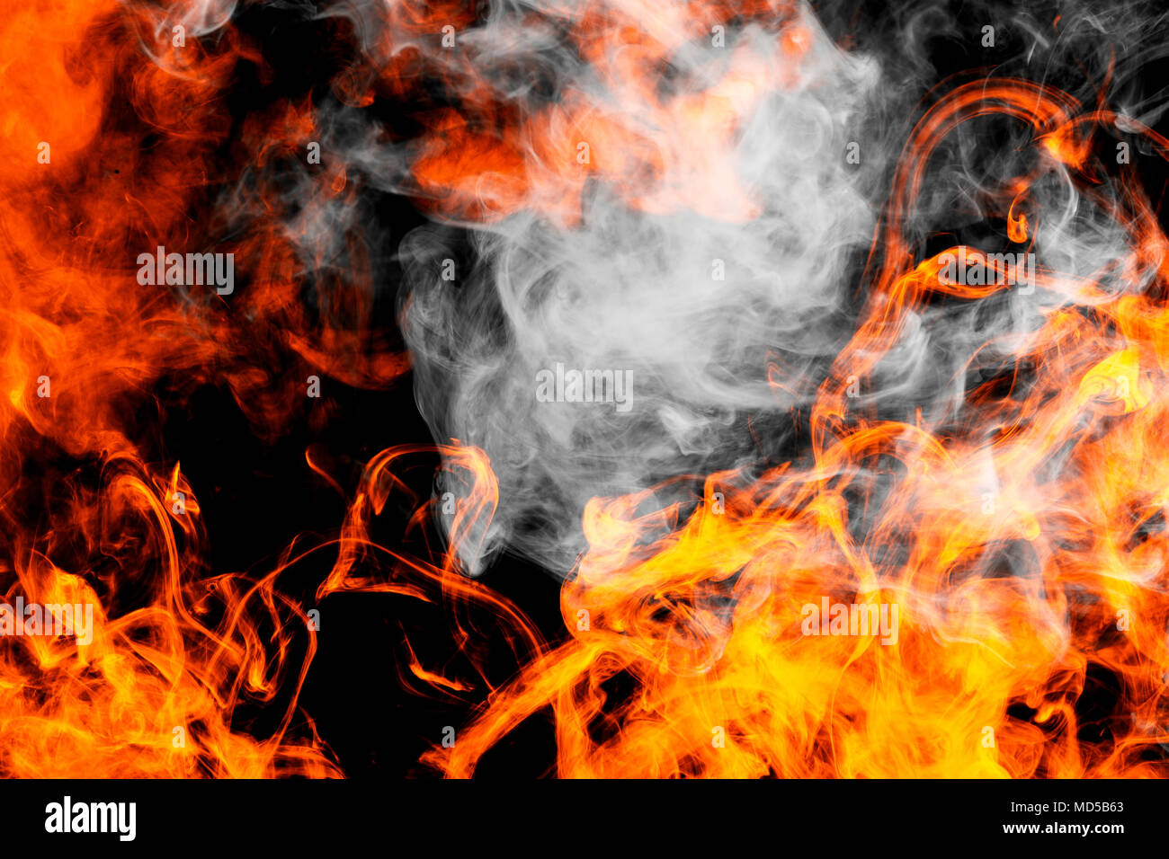 Dense fiery flames smoke on a black isolated background. Background of smoke  vape Stock Photo - Alamy