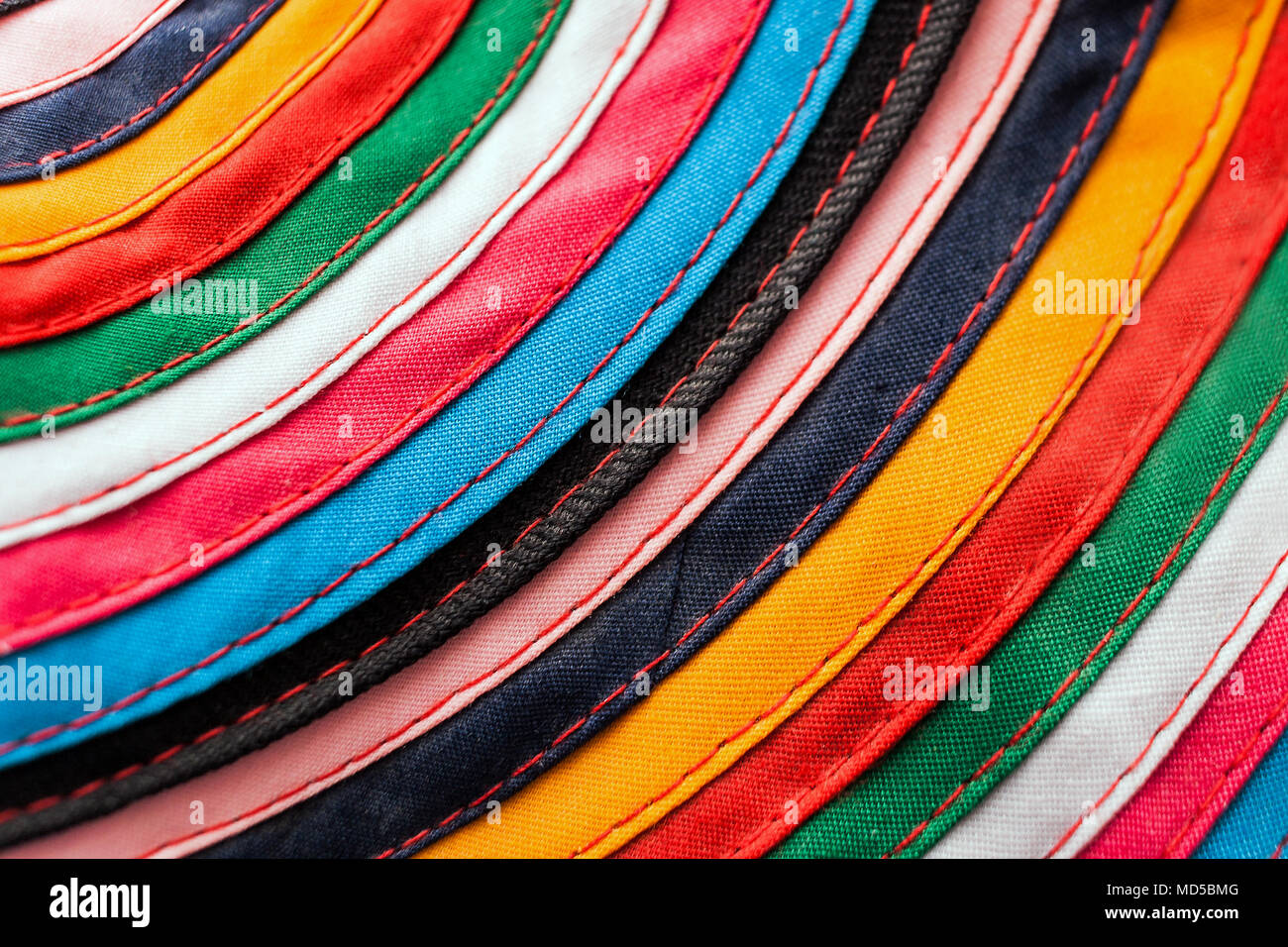 Circular handmade cloth stitched from multicolored stripes as background. Stock Photo