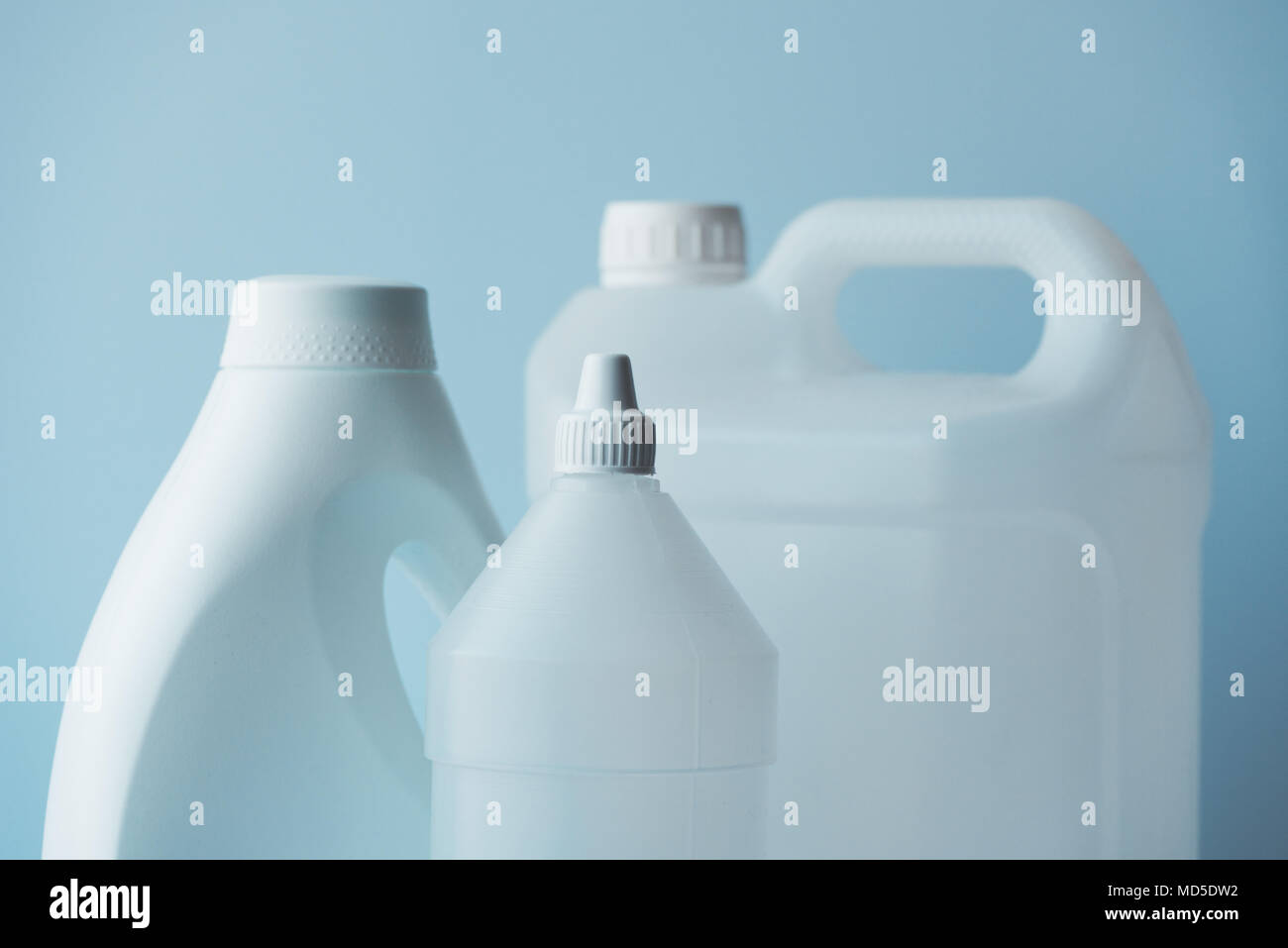 White plastic jerrycan and bottle canister for chemical liquids, blank unlabelled surface as copy space Stock Photo