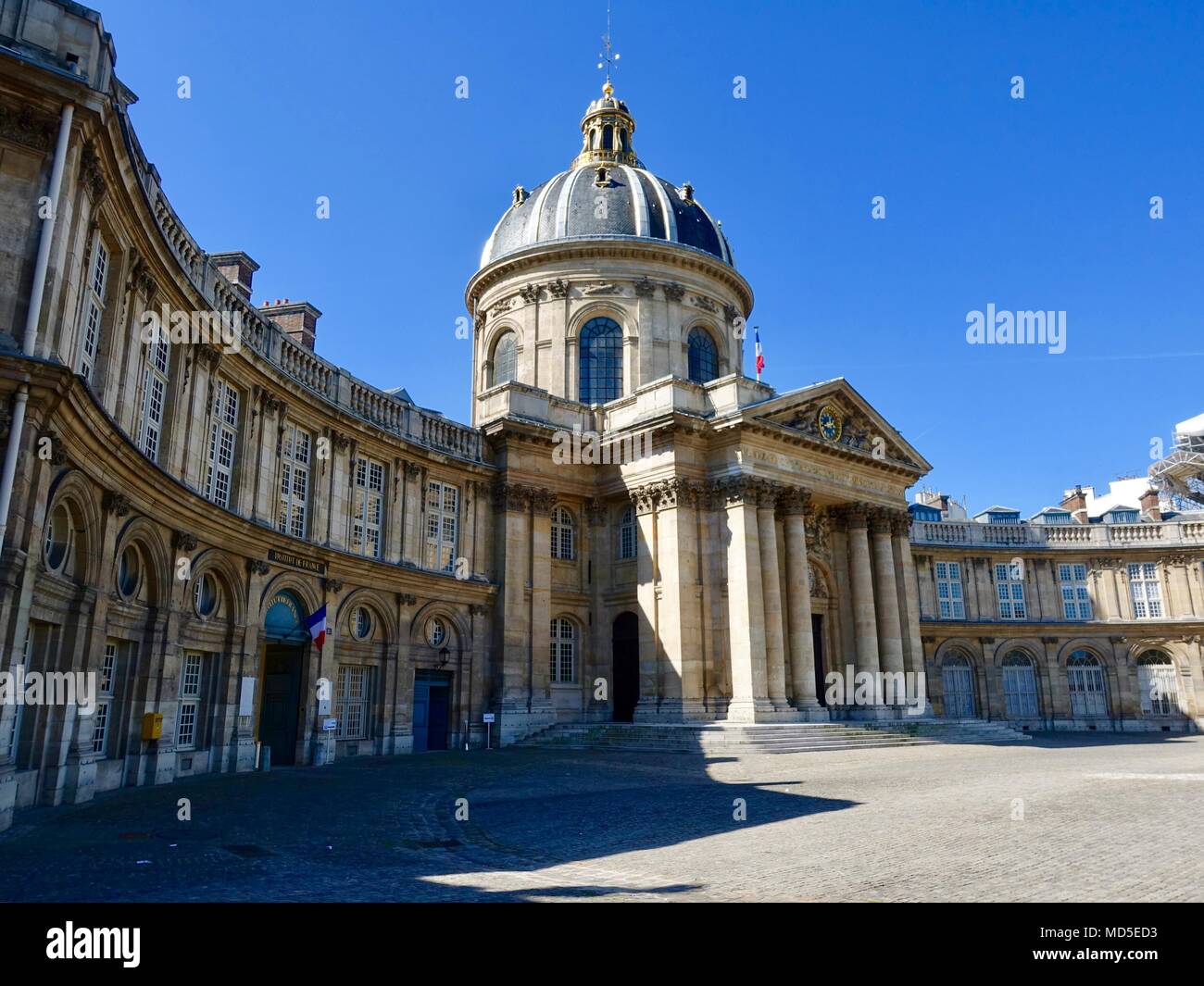 The French Institute, Académie Française, council for matters relating to French language, partly in shadow with bright blue sky, Paris, France Stock Photo