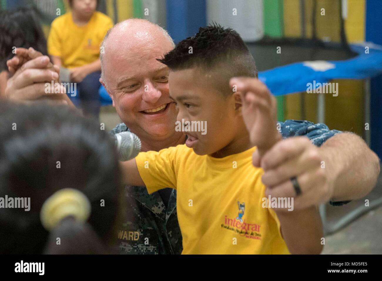 180321-N-HB733-1004 SAN PEDRO SULA, Honduras. (March 21, 2018) Chief Musician Jeremy Ward sings with a Honduran boy during a performance at the Foundation Integrar, a school for special needs students during Continuing Promise 2018. U.S. Naval Forces Southern Command/U.S. 4th Fleet has deployed a force to execute Continuing Promise to conduct civil-military operations including humanitarian assistance, training engagements, and medical, dental, and veterinary support in an effort to show U.S. support and commitment to Central and South America. (U.S. Navy photo by Mass Communication Specialist Stock Photo