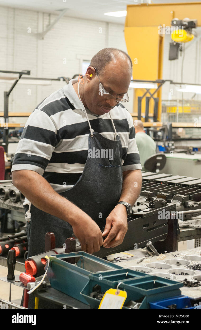 Frank Thomas installs the front sight blade on a M2A1 in Anniston Army