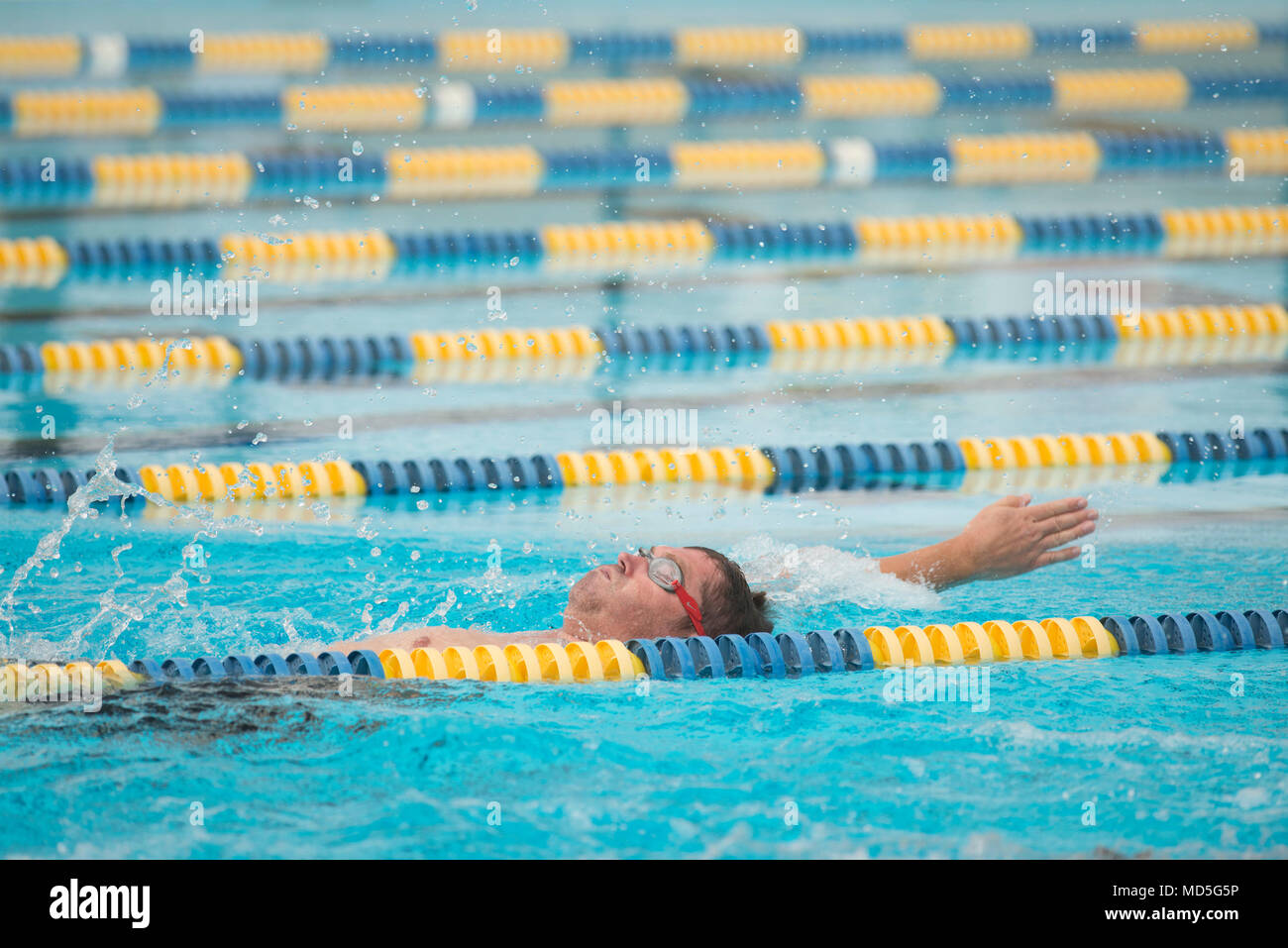 Master Sgt. Frank Reilly swims the backstroke while training