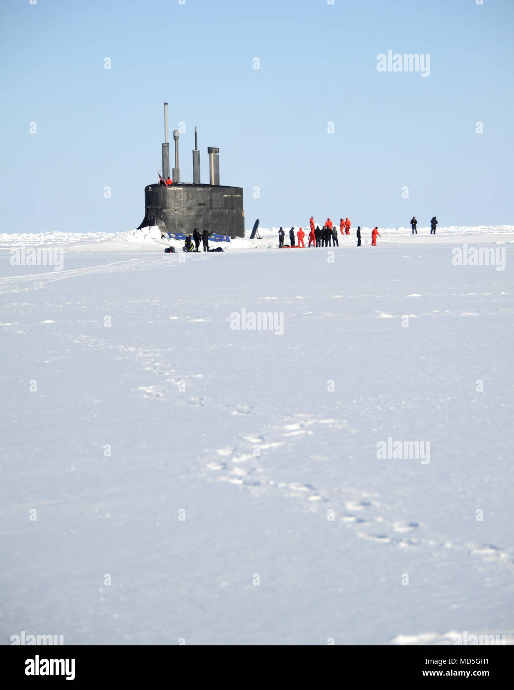 BEAUFORT SEA (March 21, 2018) Sailors of the Seawolf-class fast-attack submarine USS Connecticut (SSN 22) enjoy a breath of fresh air and a walk after surfacing through the ice during the multinational maritime Ice Exercise (ICEX) in the Arctic Circle. ICEX 2018 is a five-week exercise that allows the Navy to assess its operational readiness in the Arctic, increase experience in the region, advance understanding of the Arctic environment, and continue to develop relationships with other services, allies and partner organizations. (U.S. Navy photo by Chief Darryl I. Wood/Released) Stock Photo