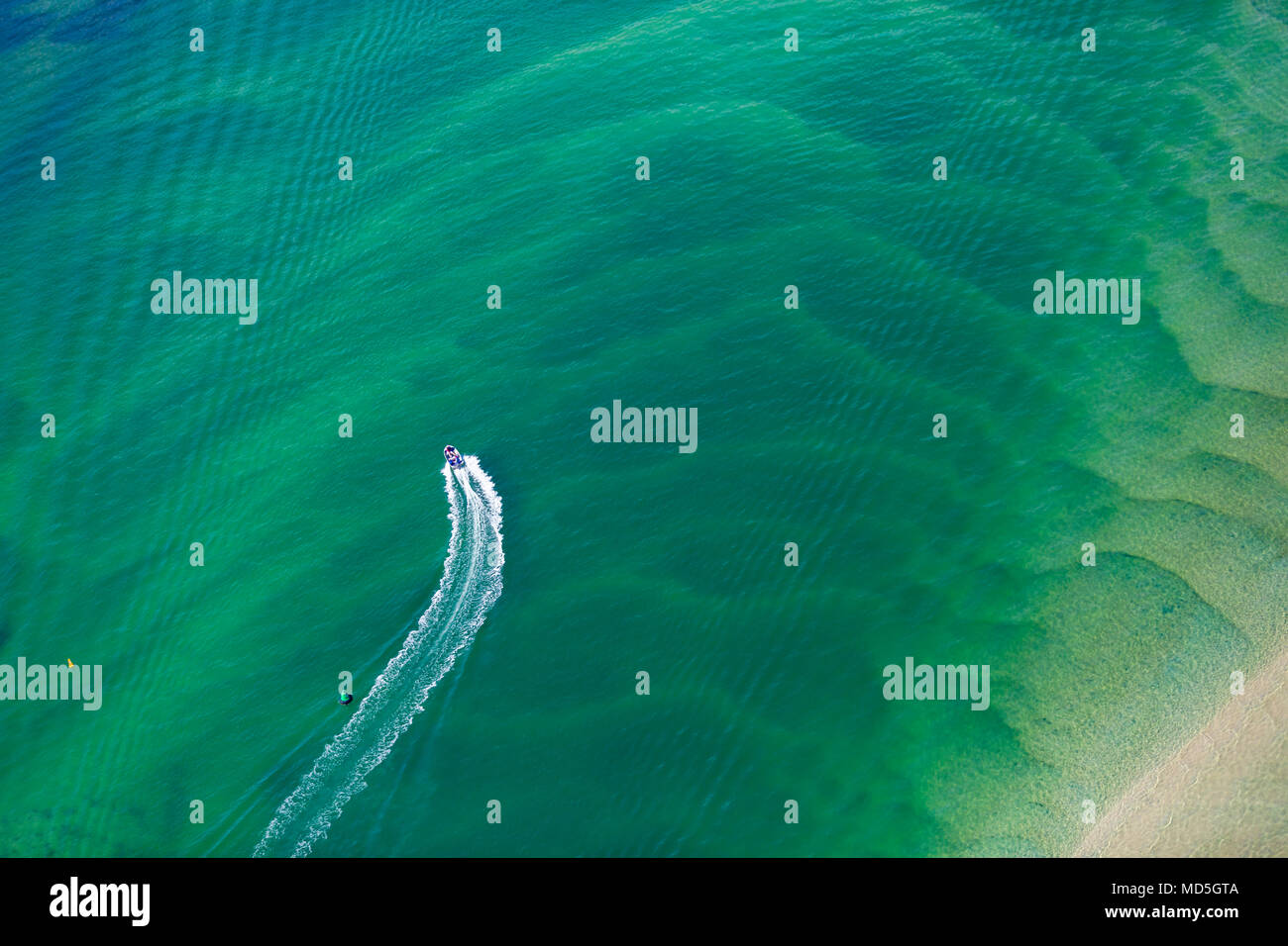 Abstract aerial photography of a boat cruising Lake Macquarie, NSW, Australia Stock Photo