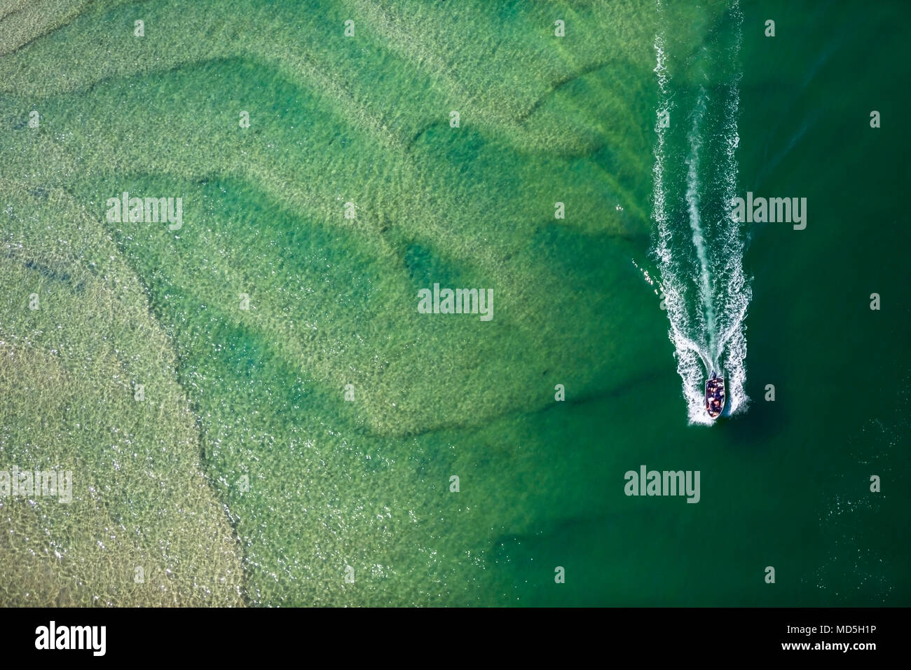 Abstract aerial photography of a boat cruising Lake Macquarie, NSW, Australia Stock Photo