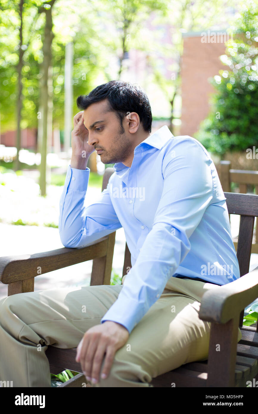 Closeup portrait, stressed young business man, hand on head, worried ...