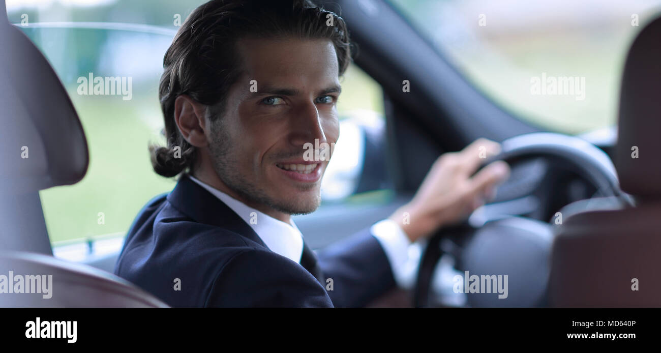 man sitting behind the wheel of a car Stock Photo - Alamy