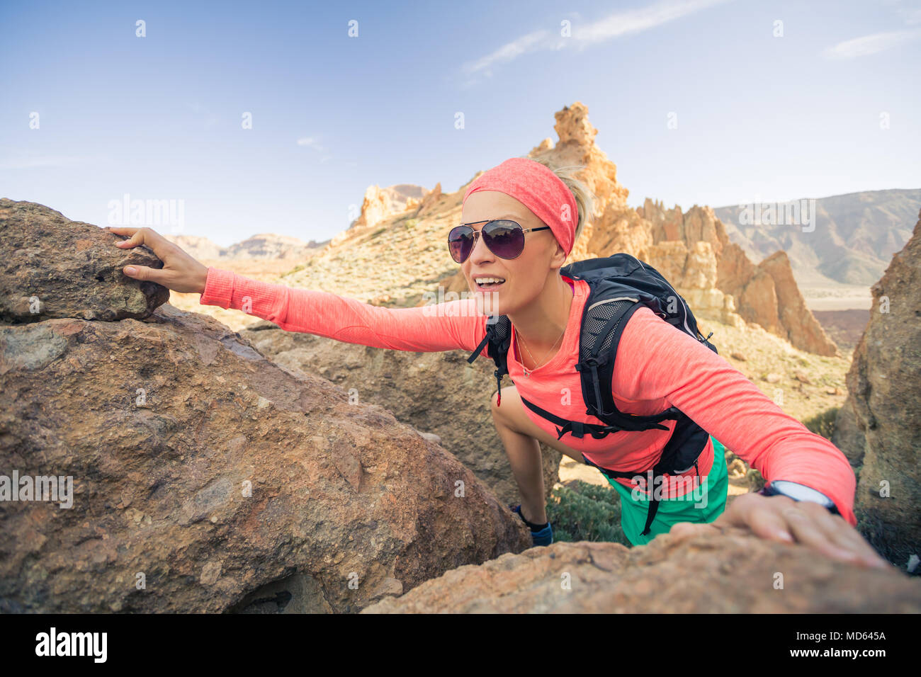 Woman hiker reached mountain top. Inspiration and motivation for weekend adventures. Female runner or climber looking at inspirational landscape on ro Stock Photo