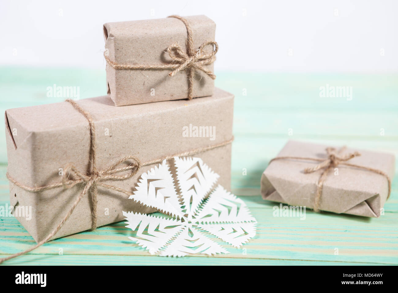 Gift boxes wrapped kraft paper tied with twine and paper snowflake and ...
