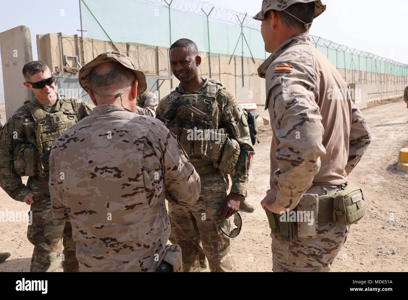 U.S. Army Command Sgt. Maj. Michael Crosby (center) Combined Joint Task Force – Operation Inherent Resolve command sergeant major, and Command Sgt. Maj. Samuel Roark (left), talk with Task Force Besmaya leaders at the Besmaya Range Complex, Iraq, March 21, 2018. The purpose of the visit was to get an update on the current and ongoing training missions in the area. Operation Inherent Resolve is the Global Coalition’s military campaign to defeat ISIS in Iraq and Syria. (U.S. Army photo by Master Sgt. Horace Murray) Stock Photo