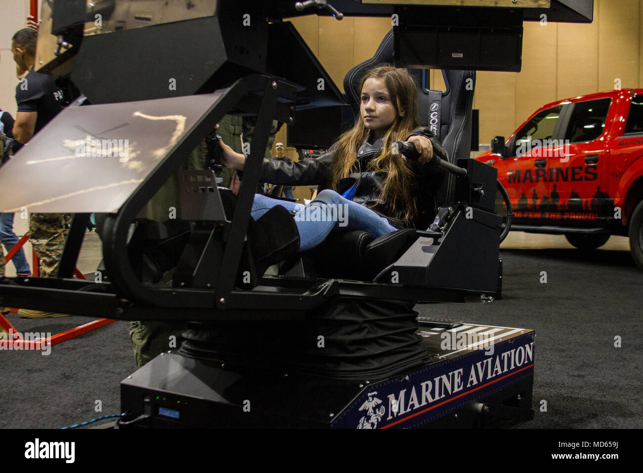 RENO, NV - 10-year-old Chloe Greer from Incline Village, Nevada, pilots an AH-1Z Viper flight simulator at the Women in Aviation, International 29th Annual Symposium in Reno, Nevada, March 24. Marines attended WAI to generate awareness for career opportunities in the Marine Corps while engaging with highly-qualified individuals and key influencers. (U.S. Marine Corps photo by Lance Cpl. Naomi Marcom) Stock Photo
