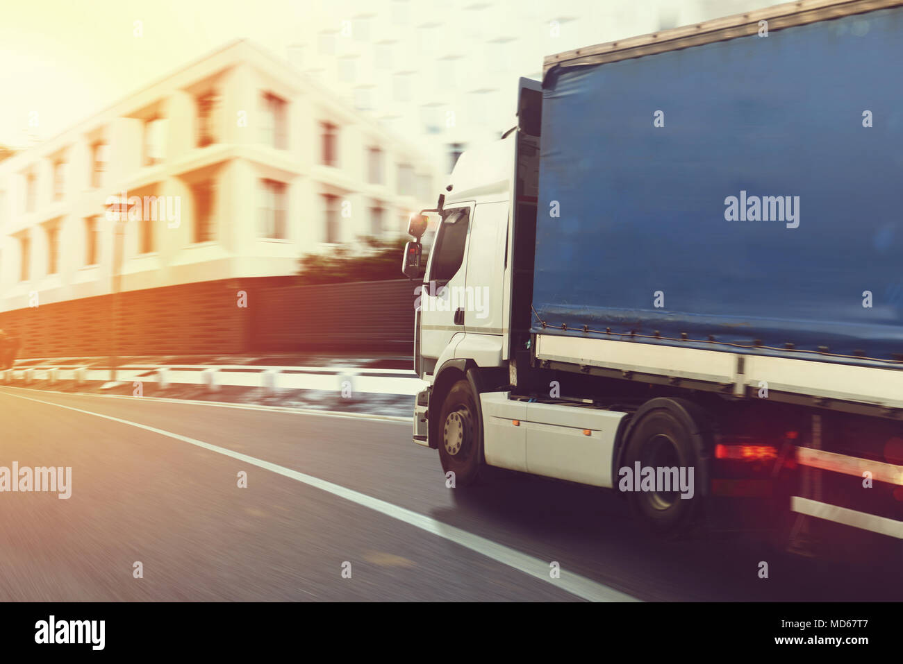 Fast truck on a city road delivering Stock Photo