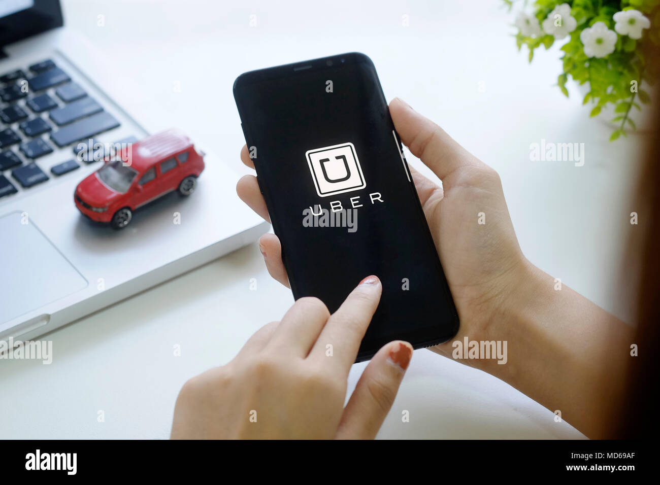 CHIANG MAI,THAILAND - FEB 18, 2018 : A woman hand holding Uber app 