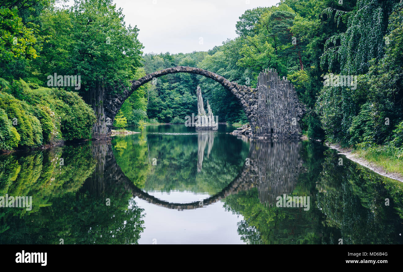 Rakotz bridge (Rakotzbrucke) also known as Devil's Bridge in Kromlau, Germany. Reflection of the bridge in the water create a full circle. Stock Photo