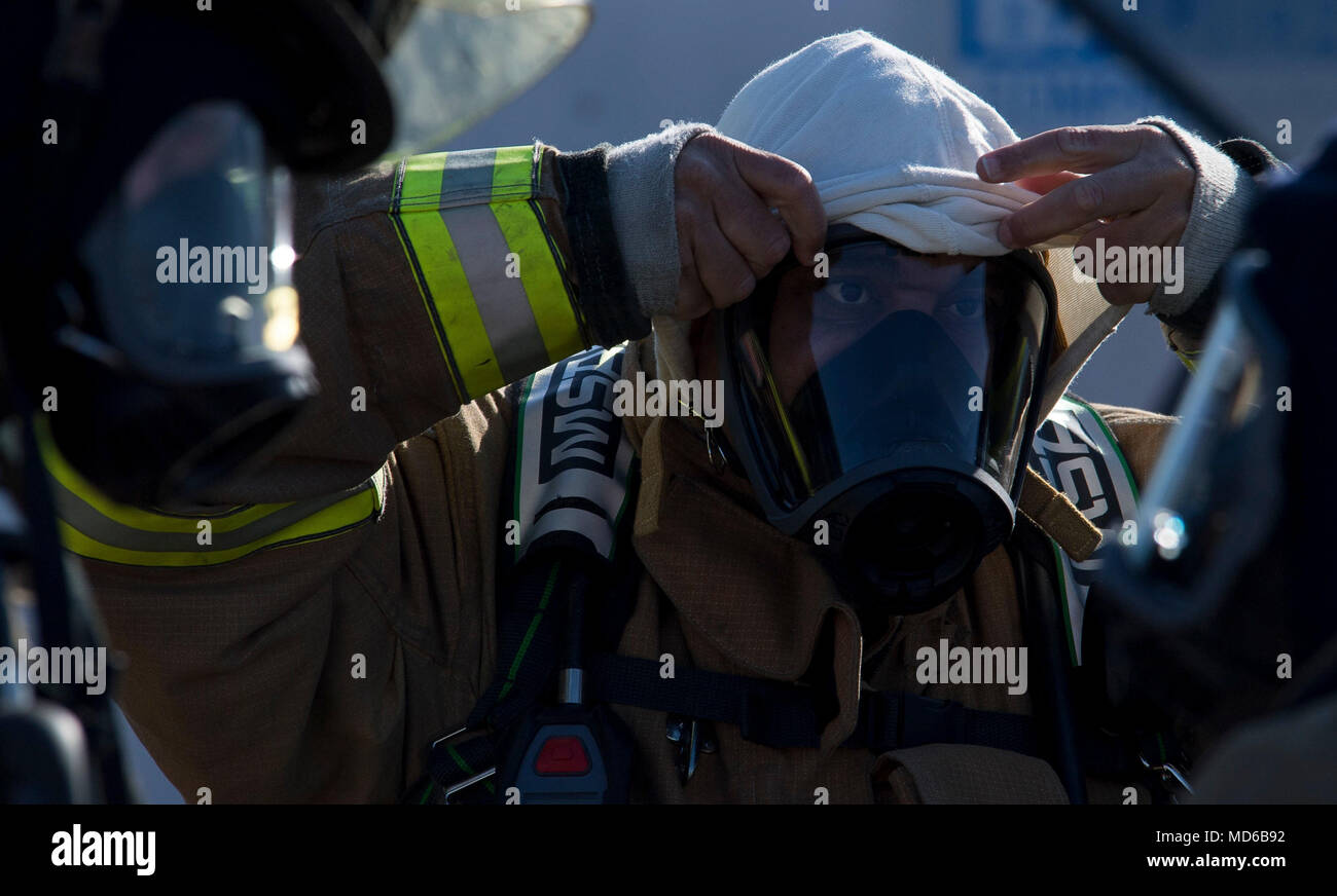 Captain Korell Cooper, Shreveport Fire Department firefighters, gears up for an annual recertification burn at Barksdale Air Force Base, La., March 21, 2018. Utilizing the burn pit on Barksdale allows the SFD to save approximately $30,000. (U.S. Air Force photo by Airman 1st Class Tessa B. Corrick) Stock Photo