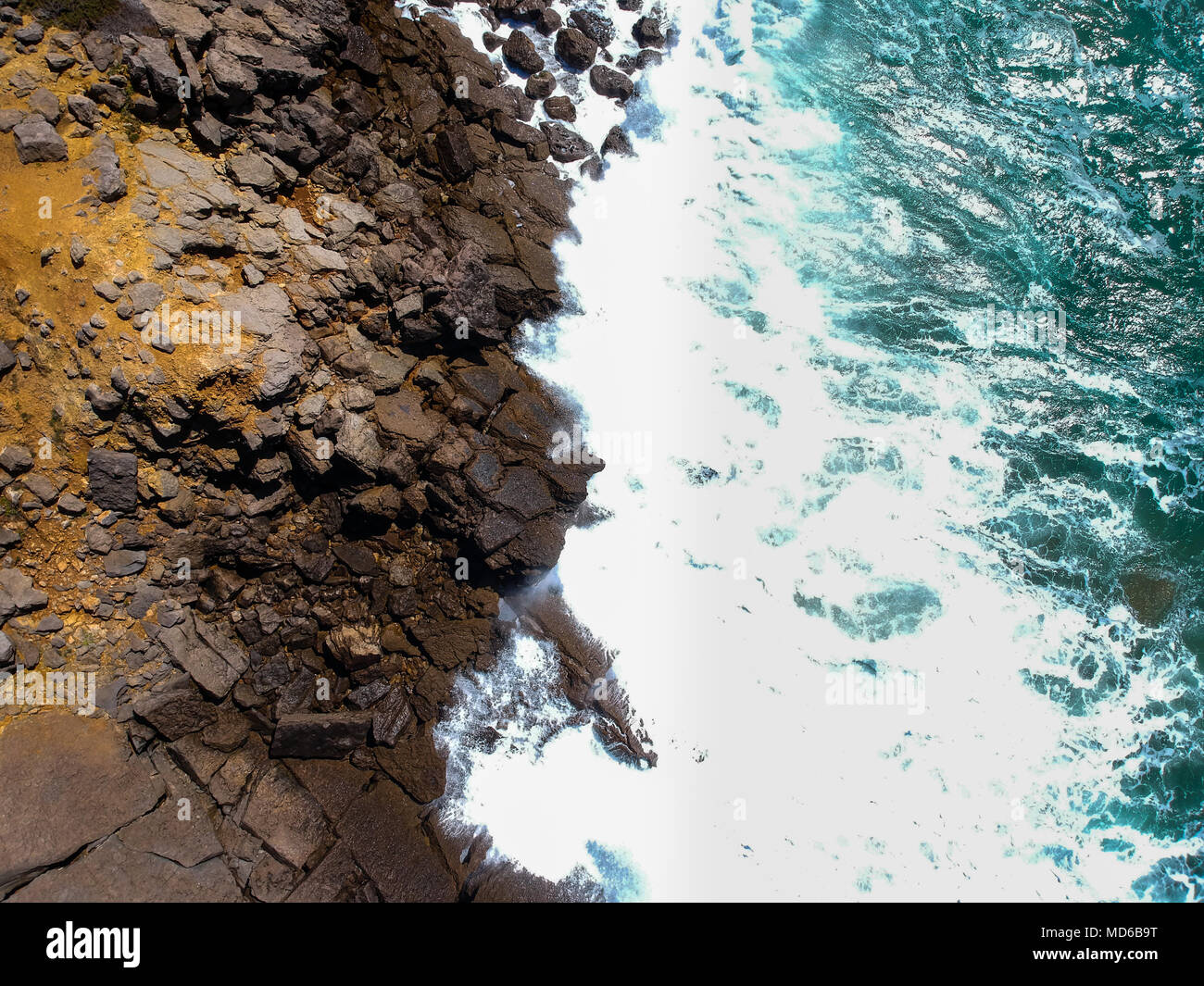 Aerial view of sea waves crash on the shoreline. Portuguese coastline ...