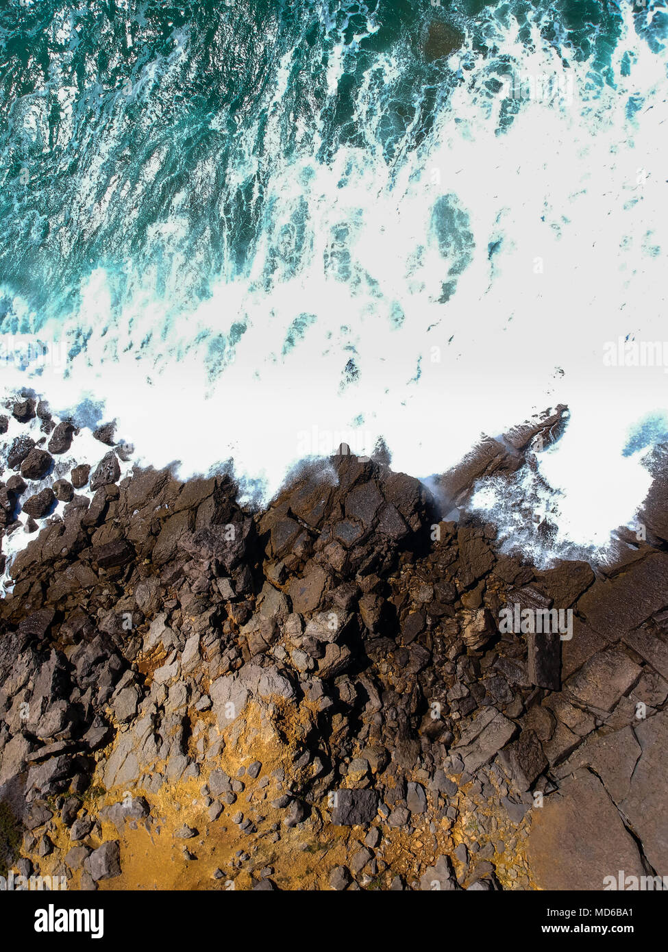 Aerial view of sea waves crash on the shoreline. Portuguese coastline ...