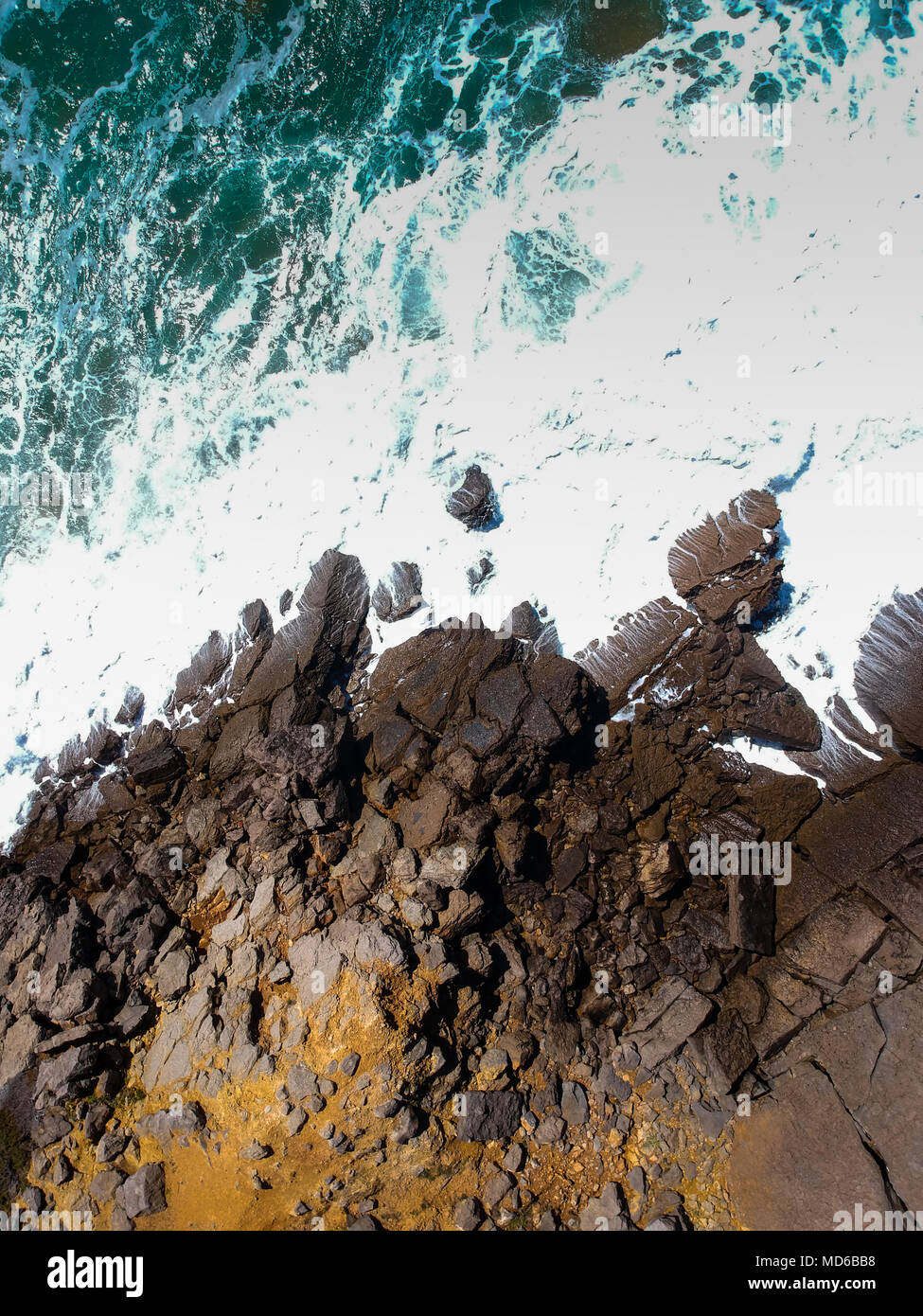 Aerial view of sea waves crash on the shoreline. Portuguese coastline ...