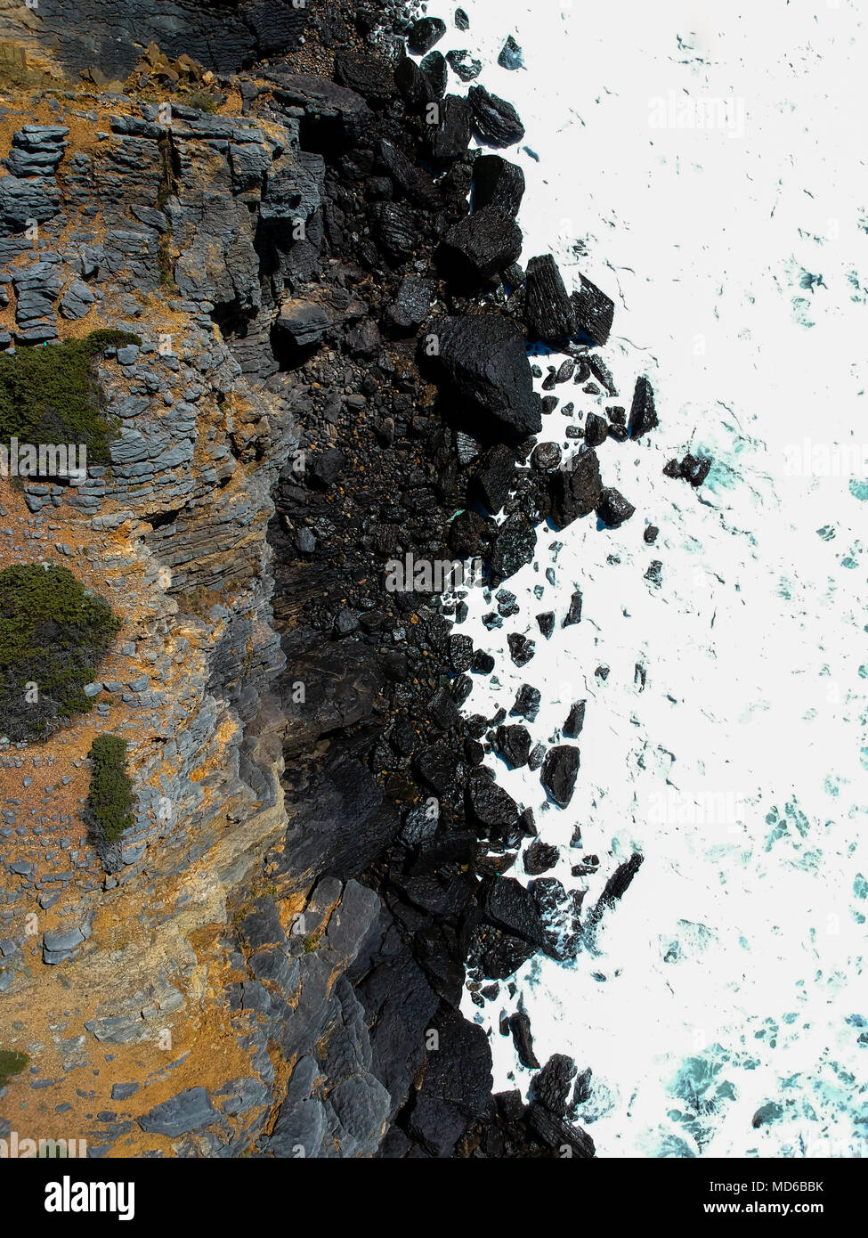 Aerial view of sea waves crash on the shoreline. Portuguese coastline ...
