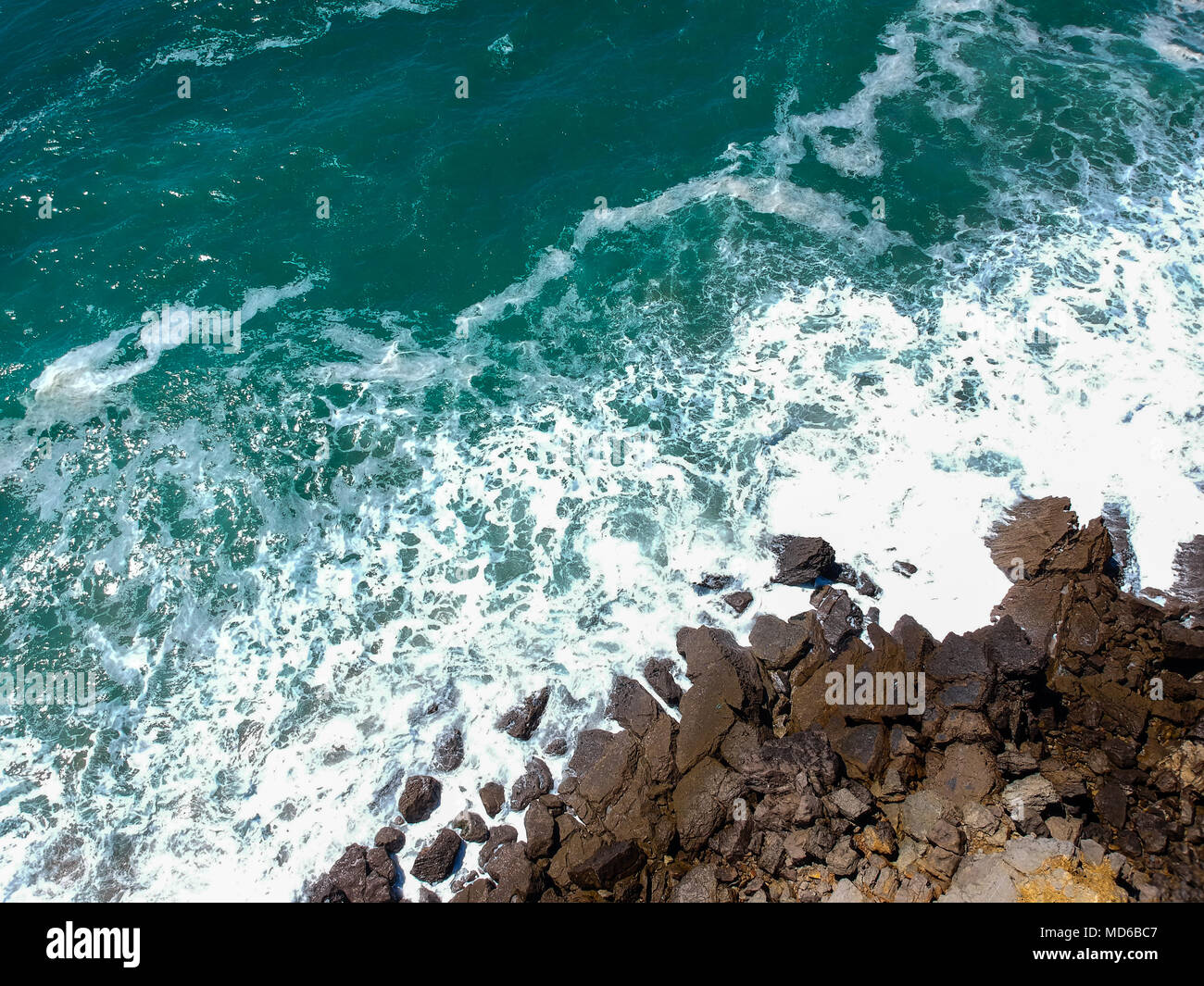 Aerial view of sea waves crash on the shoreline. Portuguese coastline ...