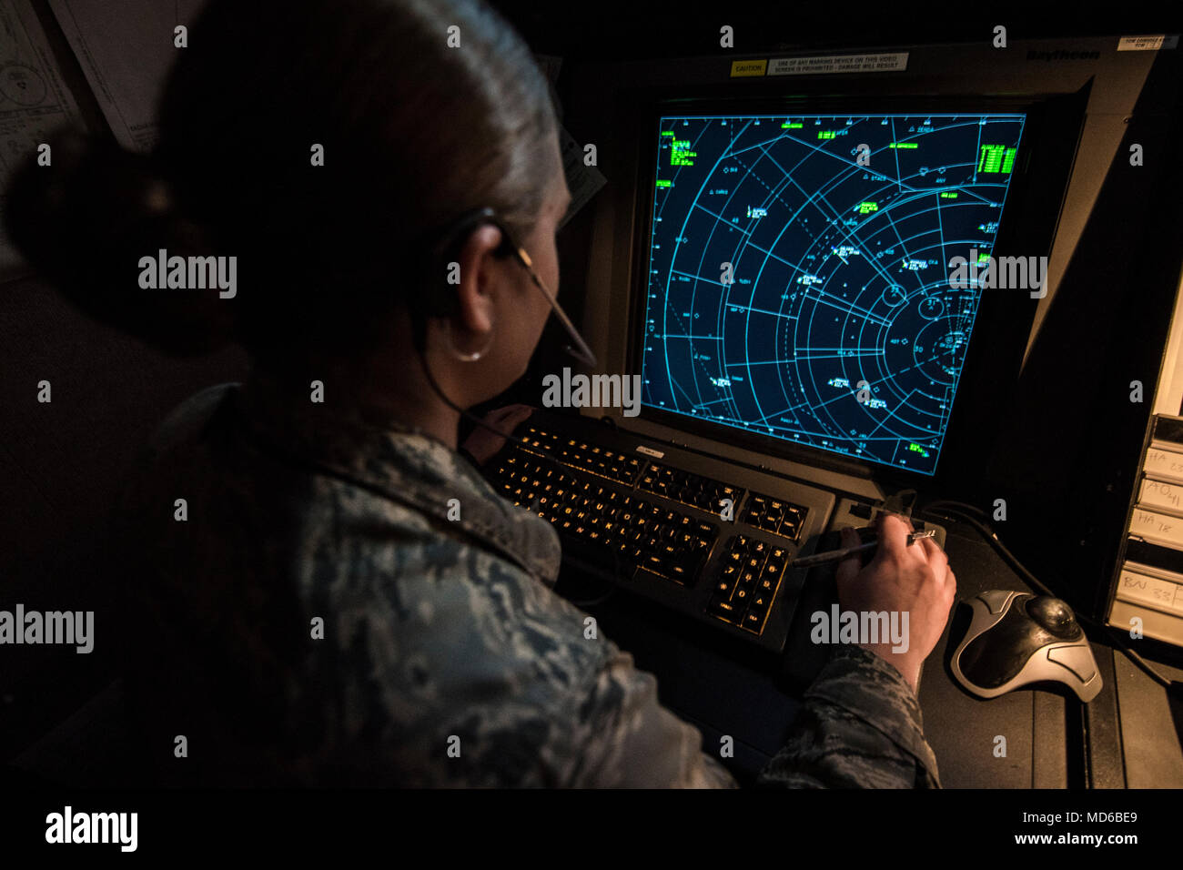 An air traffic controller trains on a simulator in the Radar Approach Control(RAPCON) facility March 22, 2018, at Vance Air Force Base, Okla. The simulator trains Airmen for day to day air traffic scenarios. (U.S. Air Force photo by Airman Zachary Heal) Stock Photo