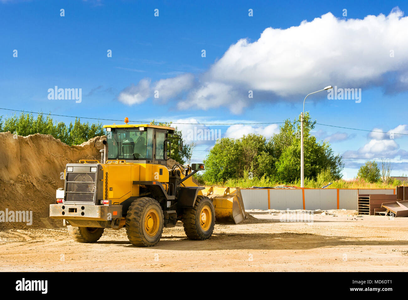 Bulldozer with bucket on construction of high-speed bypass road around Krasnoe Selo. Heavy machine equipment for excavation works at industrial constr Stock Photo