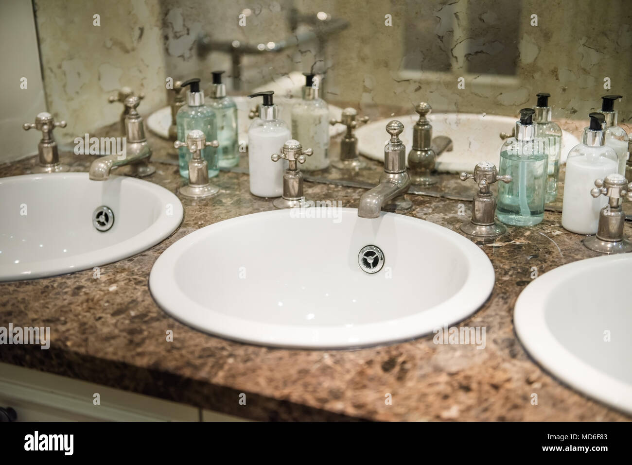 Sinks in the Public Restroom, Retro Style Mirrow and Taps Stock Photo