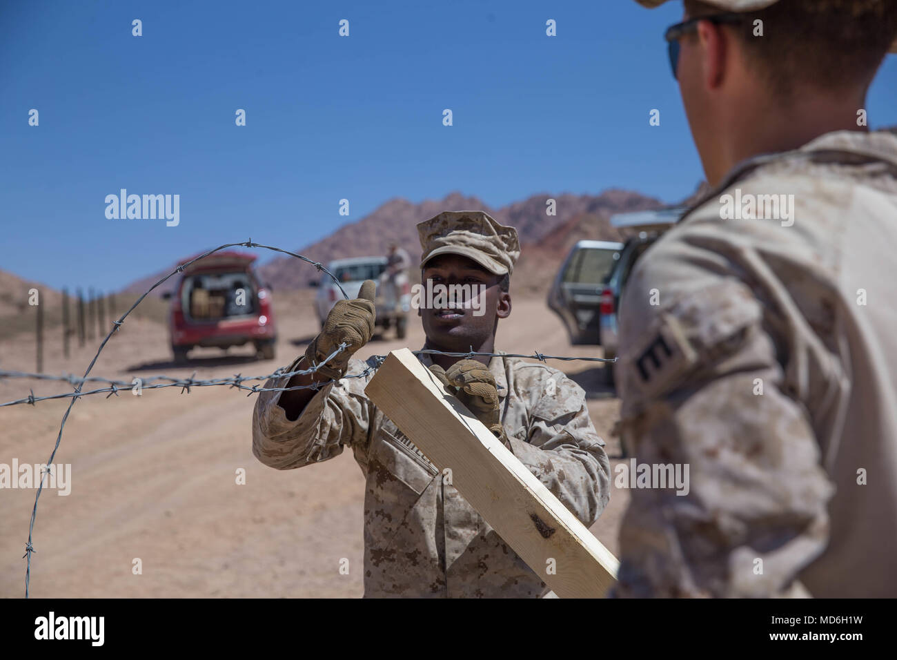 U.S. Marine Lance Cpl. Nicholas Whitley (left) and Cpl. Thomas Rousculp with Marine Wing Support Squadron 373, Special Purpose Marine Air-Ground Task Force – Crisis Response – Central Command work together to build a knife-rest aboard Camp Titin Jordan, Mar. 15, 2018. The Marines are building a live-fire range in support of exercise Eager Lion 18, a bi-lateral training event designed to exchange military expertise and improve interoperability with the U.S. military and Jordan Armed Forces. Stock Photo