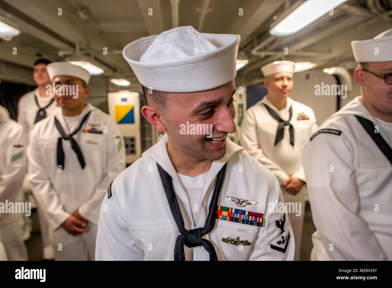 180320-N-NG136-0088 NORFOLK, Va. (March 20, 2018) Aviation Ordnanceman 3rd Class Julio Pino laughs after a service dress white uniform inspection aboard the aircraft carrier USS George H.W. Bush (CVN 77). The ship is in port in Norfolk, Virginia, conducting sustainment exercises to maintain carrier readiness. (U.S. Navy photo by Mass Communication Specialist 3rd Class Zachary P. Wickline) Stock Photo