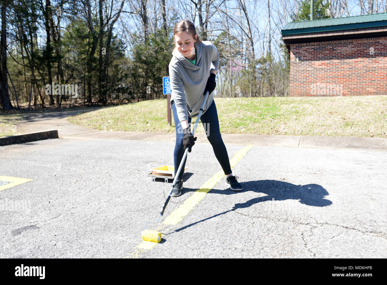 Summer Dowdy, strategic planner with VF Solutions, paints parking spot