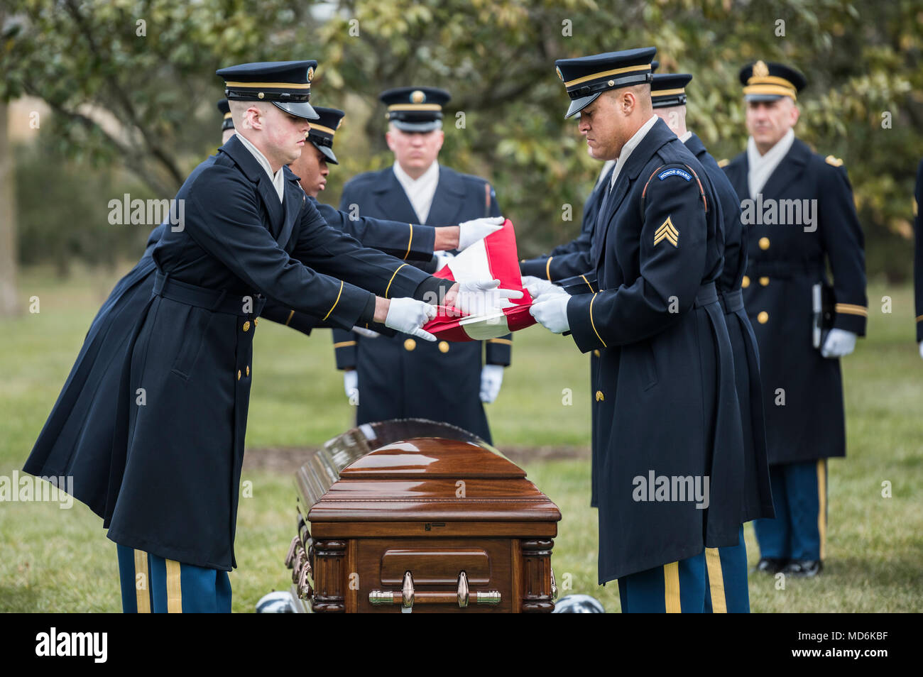 Soldiers from The U.S. Army Honor Guard folder the American flag during the full honors repatriation of U.S. Army Cpl. Dow F. Worden in Section 60 of Arlington National Cemetery, Arlington, Virginia, March 27, 2018.    Worden, 20, from Boardman, Oregon, went unaccounted in late September 1951 during the Korean War. A member of Company A, 1st Battalion, 9th Infantry Regiment, 2nd Infantry Division, Worden’s company was in the vicinity of Hill 1024 in South Korea, conducting operations near an area known as Heartbreak Ridge, when the Chinese launched an attack. The company repelled and was relie Stock Photo