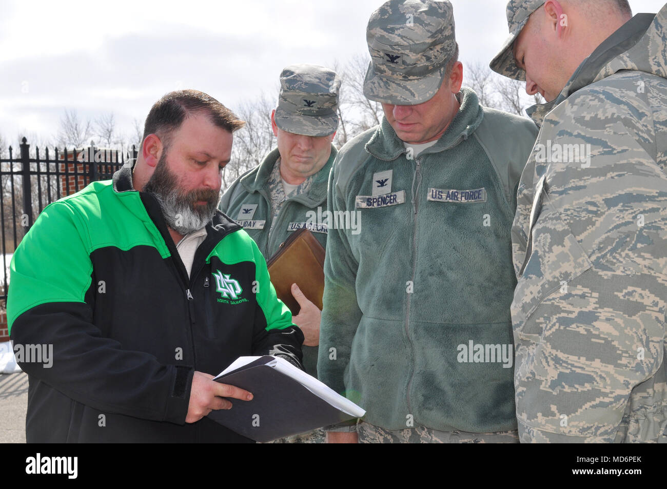 Jason Perkins, 319th Security Forces Squadron anti-terrorism program  manager (left), reviews security upgrade information with 319th Air Base  Wing leaders March 28, 2018, on Grand Forks Air Force Base, N.D. Recent  unauthorized