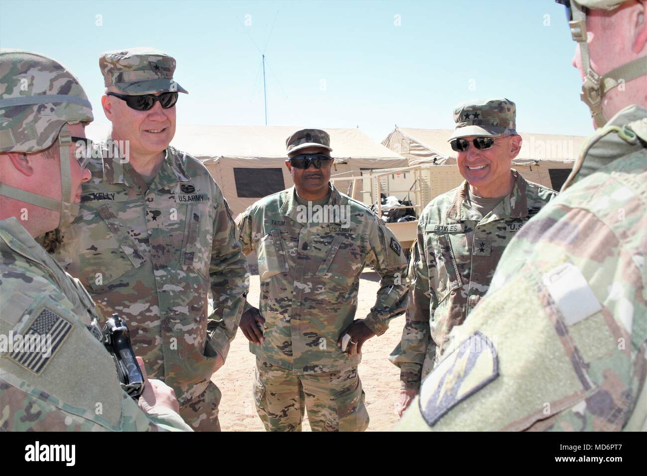 From left, Brig. Gen. Trent Kelly, the director of joint staff, Mississippi National Guard Joint Force Headquarters, Command Sgt. Maj. Sylvester Tatum, the land component Command Sgt. Maj., Mississippi National Guard, and Maj. Gen. Janson Boyles, the adjutant general of Mississippi talk to Soldiers about living in the field during a bivouac near Camp McGregor, N.M., March 20, 2018.  The command group is visiting Soldiers of the 155th ABCT training here for an upcoming deployment to the Middle East. (U.S. Army National Guard photo by Spc. Jovi Prevot) Stock Photo