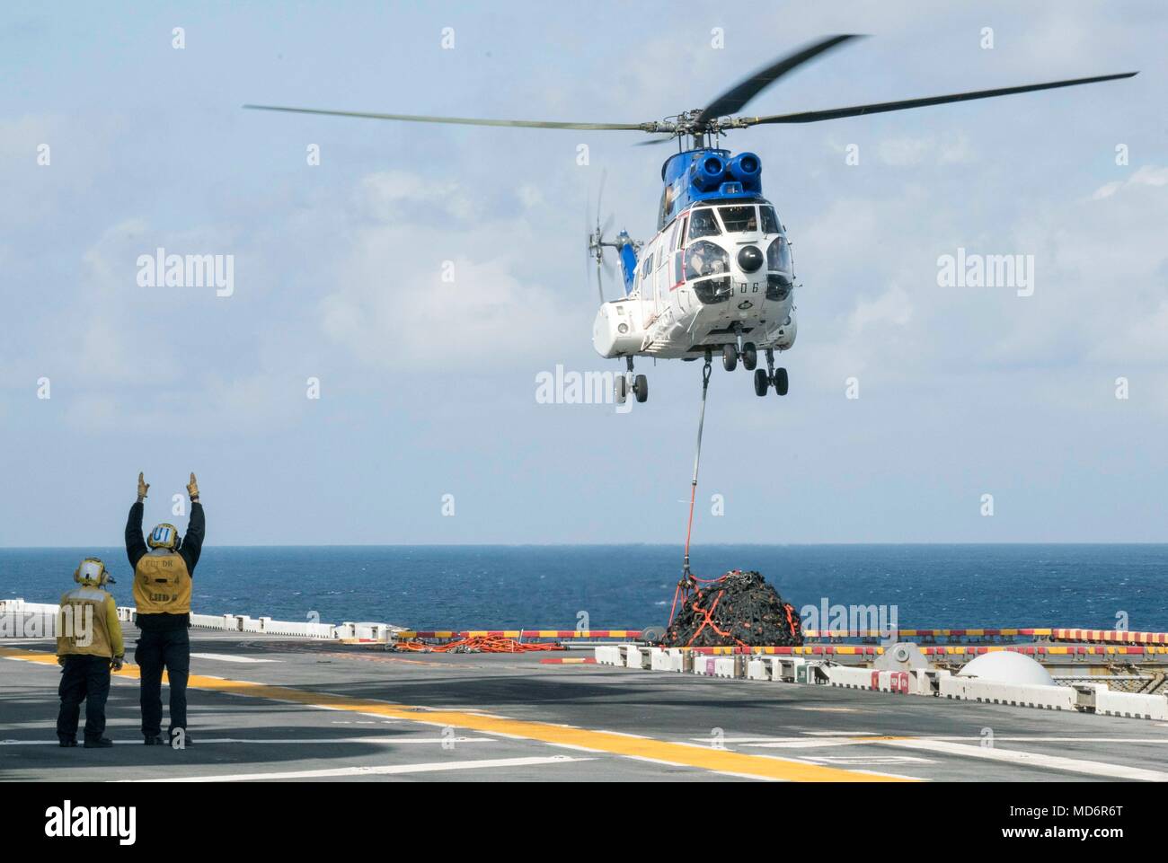 180328 N Dl434 088 Philippine Sea March 29 2018 Aviation Boatswain S Mate Handling Airman Richard Moomey Left From Cedar Rapids Iowa And Airman Terry Byrne From Clintondale N Y Signal To The Pilots Of An Sa 330