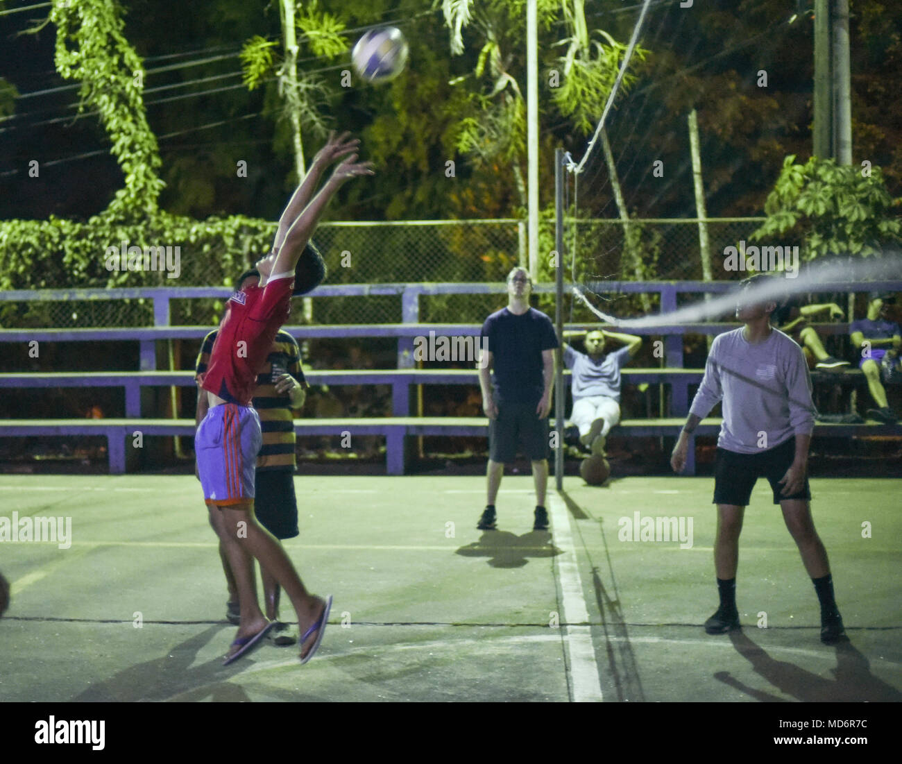 A Meteti, Panama, local citizen hits a ball during a volleyball match with U.S. military members participating in Exercise New Horizons 2018, March 27, 2018. Throughout the duration of the exercise, participants spend time engaging in sports and fun activities within the local community Exercise New Horizons is a joint training exercise where all branches of the U.S. military conduct training in civil engineer, medical and support services while benefiting the local community. (U.S. Air Force photo by Senior Airman Dustin Mullen/Released) Stock Photo