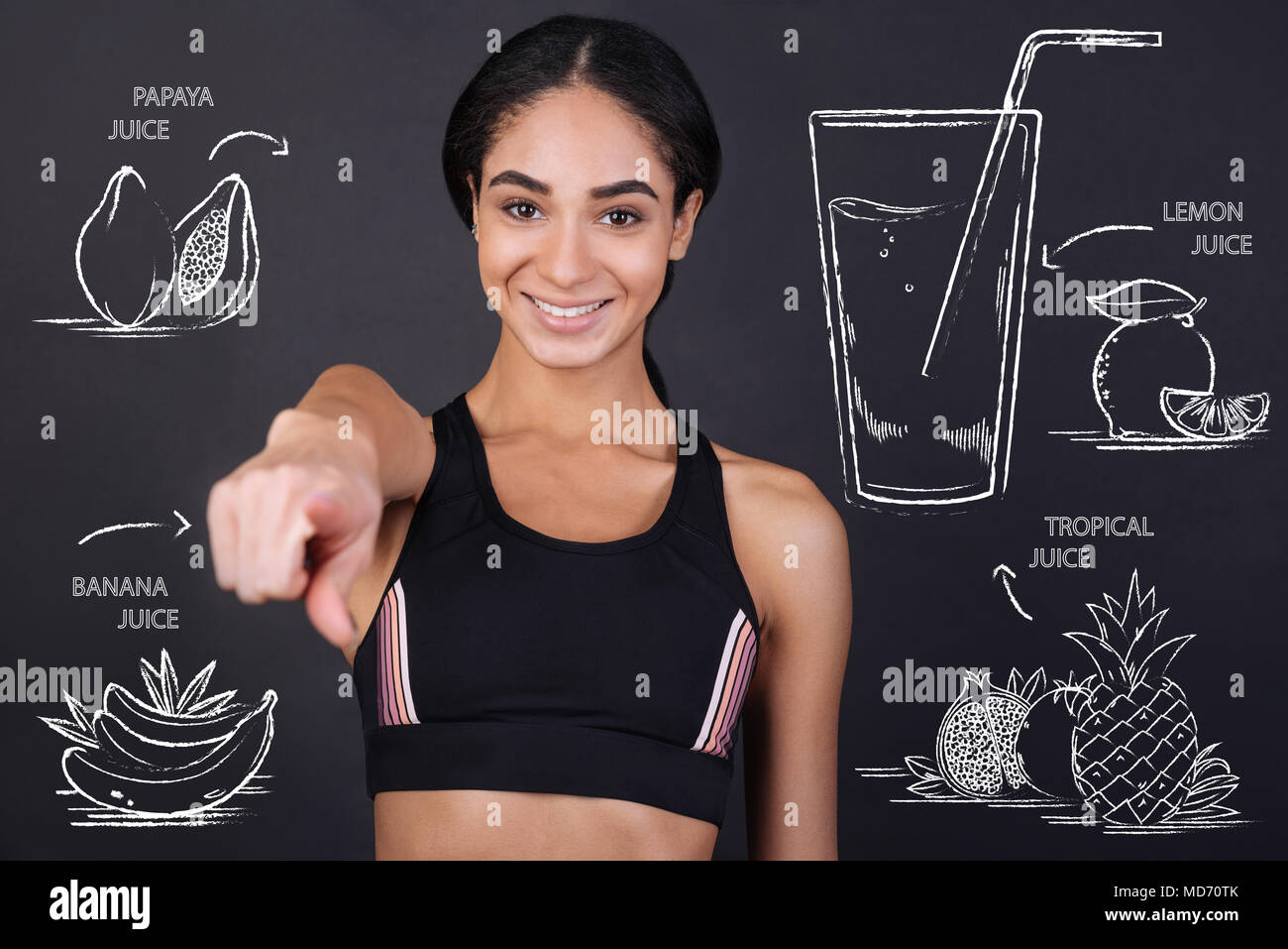 Young nutrition expert pointing in front of herself while talking about juice Stock Photo