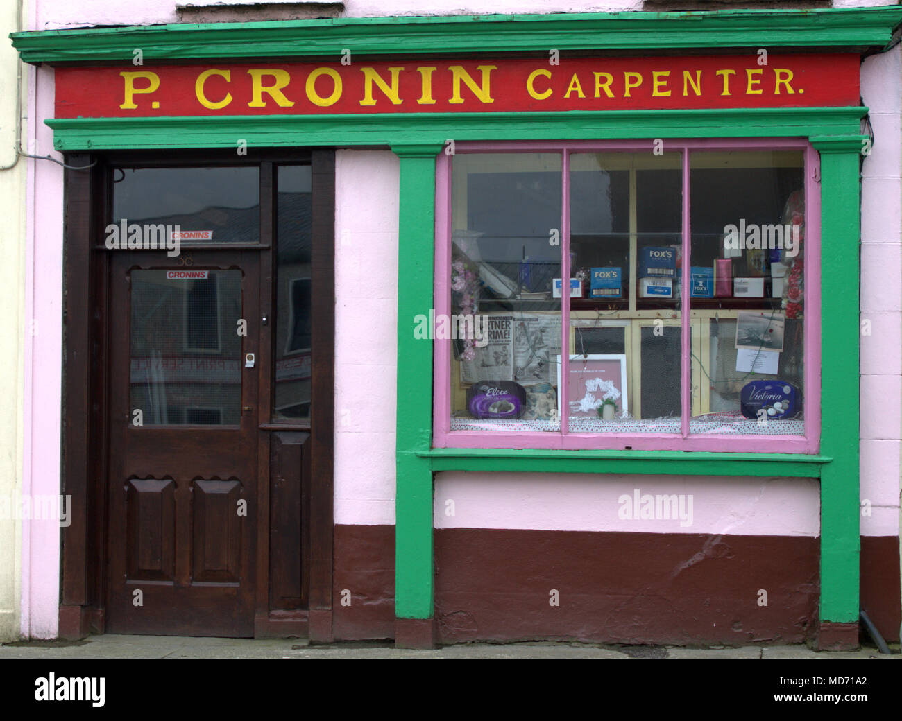 brightly coloured shop front signed as a carpenters in the popular holiday town of skibbereen, ireland. A tourist destination in west cork. Stock Photo