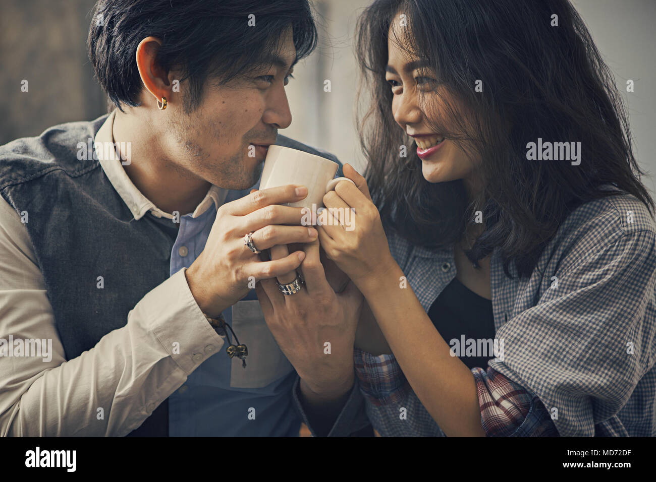 couples of asian younger man and woman happiness emotion with hot coffee  cup in hand Stock Photo - Alamy