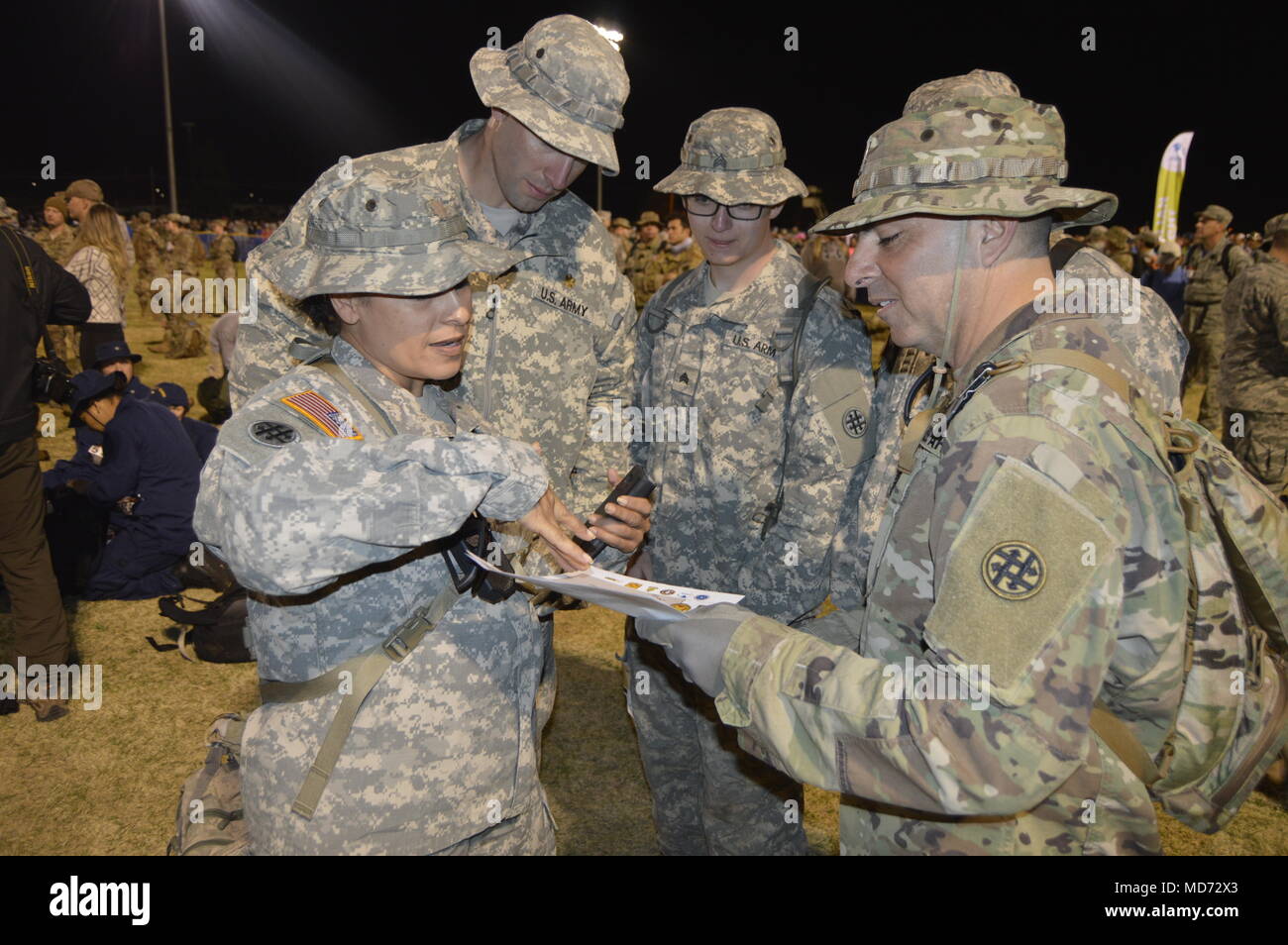 U.S. Army Reserve Maj. Linda Zamora with the 372nd Quartermaster Battalion (Petroleum Support) stationed at Kirtland Air Force Base, New Mexico, briefs her team on the route for the 2018 Bataan Memorial Death March at White Sands Missile Range, New Mexico, March 25, 2018. This is Zamora’s 13th time participating in the event. The Bataan Memorial Death March honors the U.S. service members and Filipino Soldiers that were forced marched 65 miles by the Japanese Army through the Philippine jungle in April of 1942. Events like this challenge a Soldier’s body and mind, while ensuring America’s Army Stock Photo