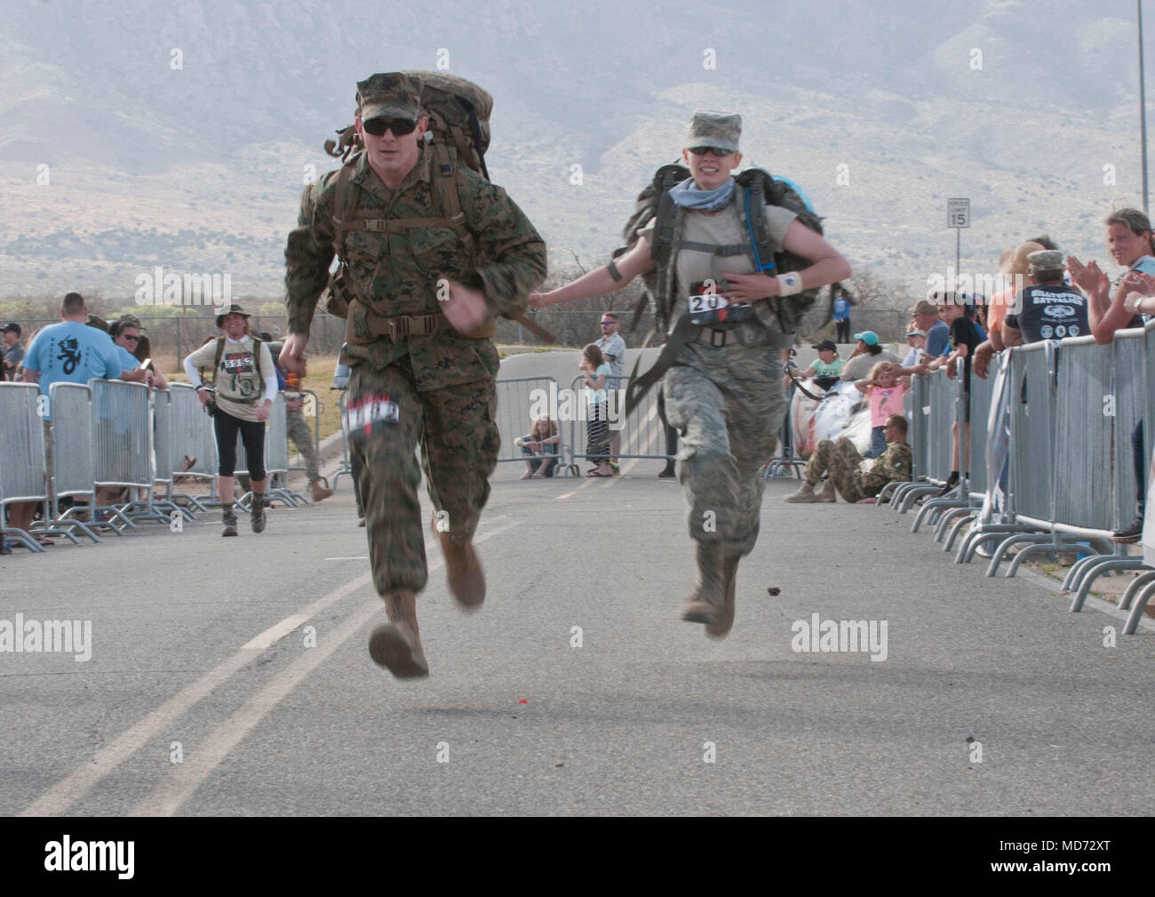A Marine and an Airman race to the finish line at the 2018 Bataan