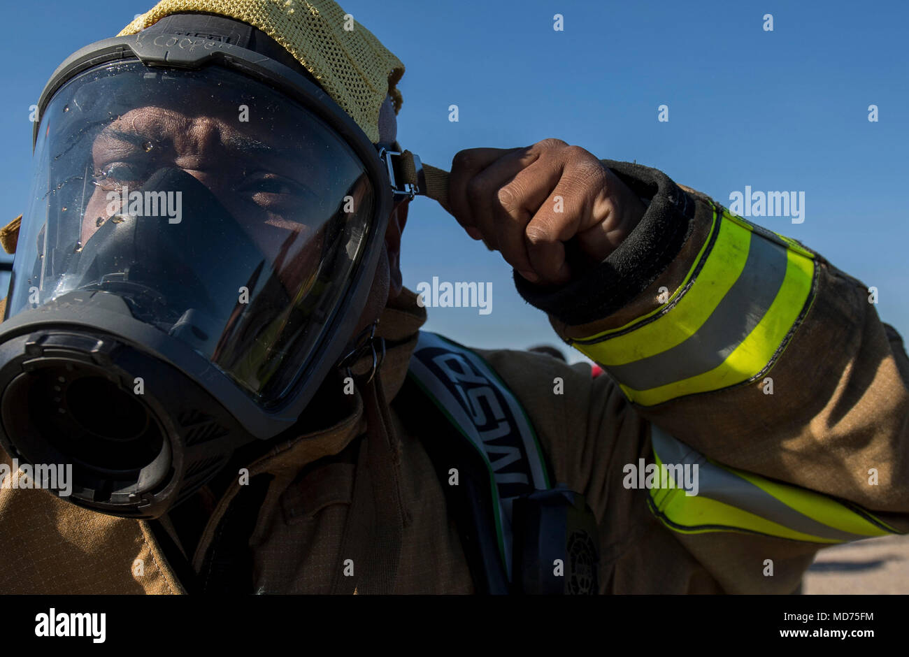Captain Korell Cooper, Shreveport Fire Department firefighters, gears up for an annual recertification burn at Barksdale Air Force Base, La., March 21, 2018. Utilizing the burn pit on Barksdale allows the SFD to save approximately $30,000. (U.S. Air Force photo by Airman 1st Class Tessa B. Corrick) Stock Photo