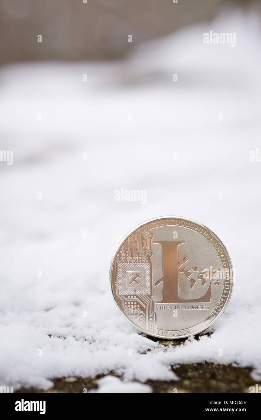 A silver litecoin placed in snow on concrete. Isolated scene of  cryptocurrency in snow Stock Photo - Alamy