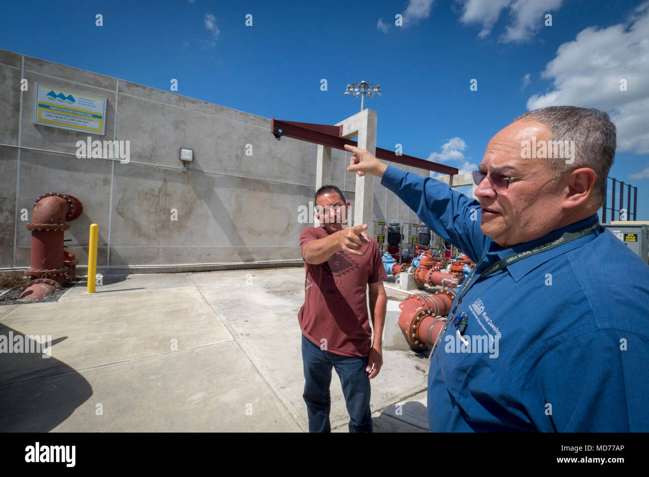 Juan Reyes with the Puerto Rico water authority shows USDA Loan Officer Julio Chevres at the water treatment facility in Caguas that was built with UDSA fund. Stock Photo