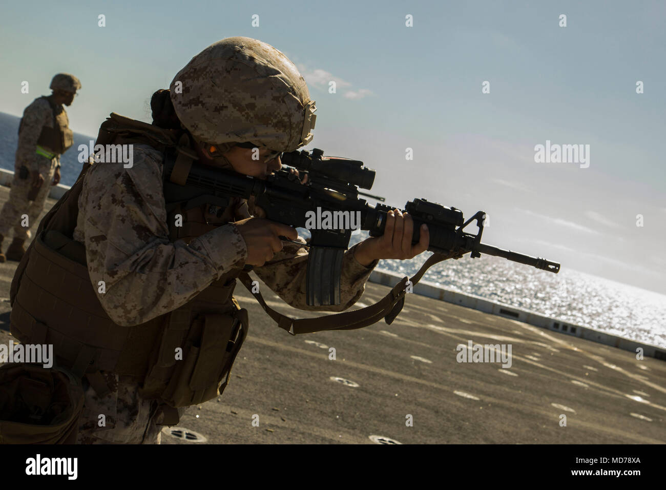 MEDITERRANEAN SEA (March 30, 2018) Marine Corps Sgt. Daneth Cueto , an embark specialist assigned to Combat Logistics Battalion 26, 26th Marine Expeditionary Unit (MEU) fires her M4 carbine rifle during a deck shoot aboard San Antonio-class amphibious transport dock USS New York (LPD 21) March 30, 2018. The MEU maintains a constant state of readiness by doing routine weapons familiarization and deck shoots while deployed to U.S. 6th Fleet area of operations. U.S. 6th Fleet, headquartered in Naples, Italy, conducts the full spectrum of joint and naval operations, often in concert with allied an Stock Photo